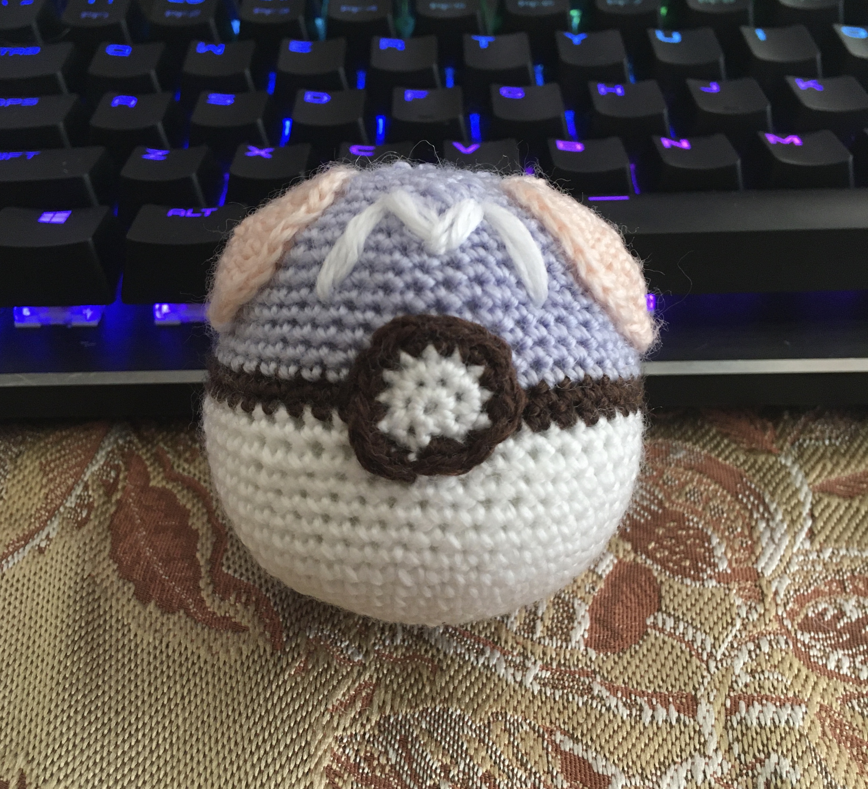 pictured: An Amigurumi crochet of a Pokemon Master Ball.